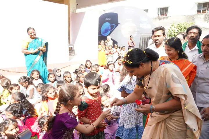 With schoolchildren in the yard