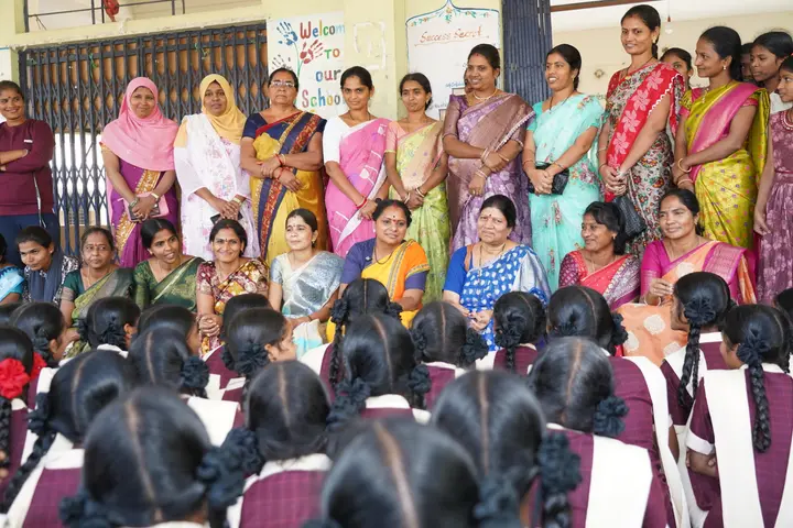 With teachers and students at the school
