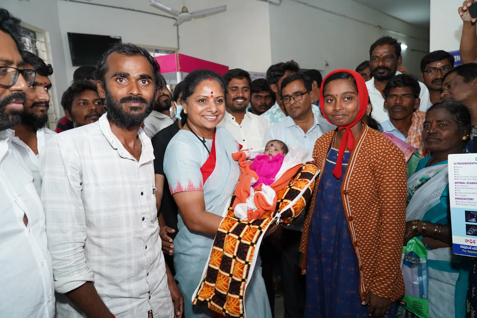 K Kavitha with a family and their newborn