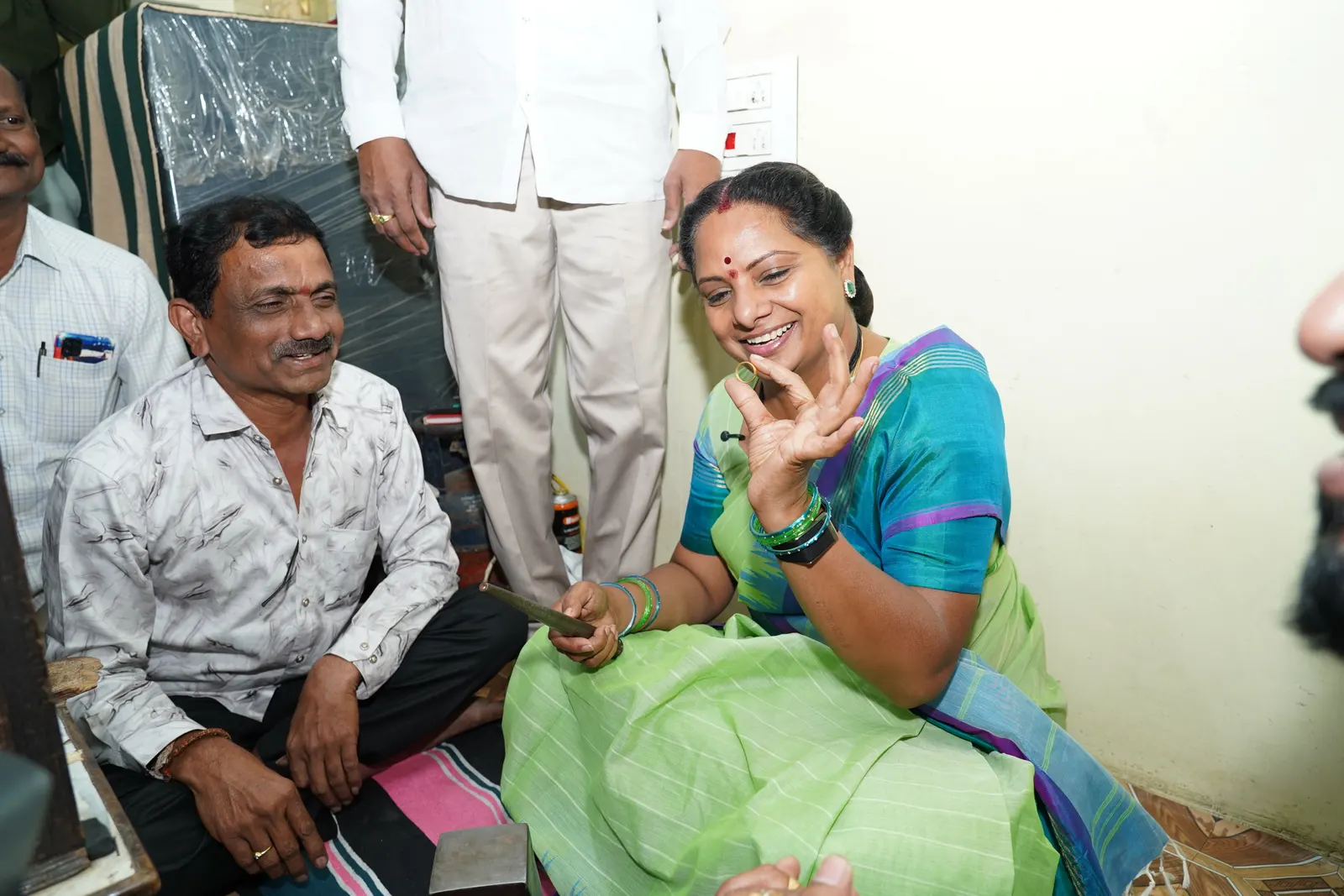 K Kavitha sitting with a household